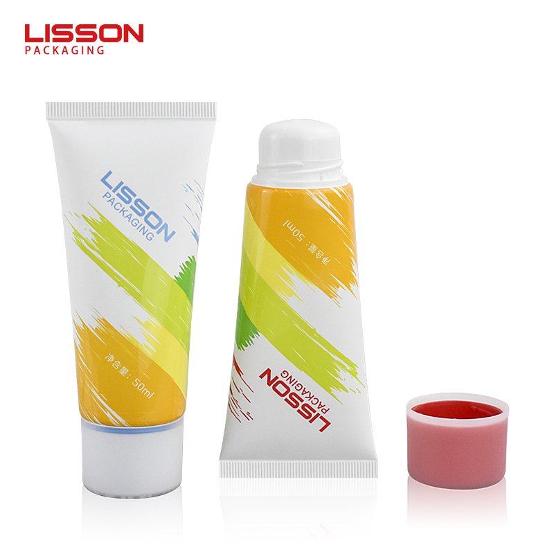 Crema depilatoria con tapón de doble color en tubo